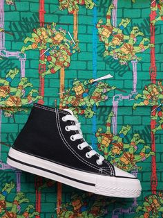 This is not a licensed Nickleodeon Product. It is however, handcrafted from licensed Nickleodeon fabric purchased from a licensed supplier. I am not affiliated with or sponsored by Nickleodeon. My prices reflect the cost of the shoe and my time to apply the fabric.  I do not charge for the fabric. Fantastic Licensed Teenage Mutant Heroe turtle fabric, hand decorated converse style high top shoe. Great for teenage mutant heroe turtle enthusiasts! You can choose the option to have just the outside of your shoes customised, (the ankle sides) and leave the instep sides blank - Option - Outsides only. Or or you can choose both the ankle sides and the instep sides, (the whole shoe) - Option - Outsides and Insides Please tell me which basic shoe colour you would like from all white, all black or School Lace-up High-top Sneakers With Rubber Sole, High-top Canvas Sneakers For School, Lace-up High-top Sneakers With Rubber Sole For School, High-top Cotton Sneakers For School, Decorated Converse, Must Have Shoes, Turtle Theme, Style Converse, High Top Shoe