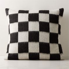 a black and white checkered pillow sitting on top of a table