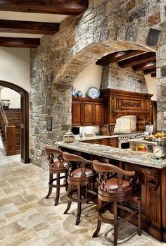 a large kitchen with an island in the middle and lots of stools around it