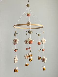 a mobile made out of felt balls hanging from a ceiling fixture in a child's room