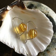 The pictures do not do justice to these gorgeous 100% Genuine Grade AAA Citrine Earrings.  I made these in a very simple popular design to not take away from the beauty of these beautiful 8mm gemstones.  These are made from sterling silver and will hang 7/8th on an inch from your piercing.  A minimalist but unique design that enhances these quality gems.  A great choice for a birthday or special occasion gift!  Made especially for you in my studio on the Pacific Northwest Islands!So I am thinkin Minimalist Amber Earrings For Gift, Handmade Round Citrine Earrings, Nickel-free Round Amber Jewelry, Minimalist Round Birthstone Earrings, Hypoallergenic Round Earrings For Birthday, Minimalist Round Stone Earrings For Gift, Minimalist Round Stone Earrings As Gift, Yellow Minimalist Round Earrings, November Zodiac