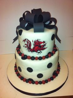 a white cake with black and red decorations