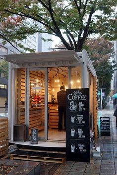 a small coffee shop on the side of a street