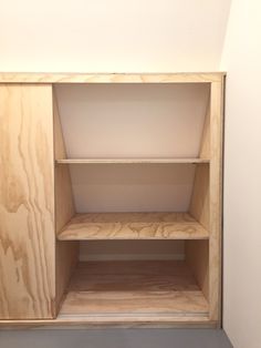 an empty shelf in the corner of a room