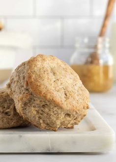 two oatmeal muffins sitting on top of a white plate