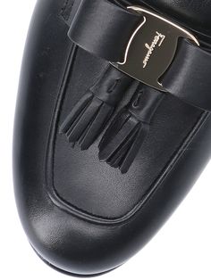 Ferragamo 'Vara' bow mules, black leather, round toe, upper bow detail, upper gold logo plaque, slip-on fit, leather sole. Luxury Slip-on Tassel Loafers For Work, Luxury Tassel Loafers Slip-on For Work, Luxury Tassel Loafers With Leather Lining For Work, Luxury Calf Leather Tassel Loafers, Luxury Calf Leather Tassel Loafers For Galas, Luxury Calf Leather Tassel Loafers For Office, Luxury Tassel Loafers For Workwear, Luxury Leather Sole Tassel Loafers For Work, Luxury Tassel Loafers With Leather Sole For Work