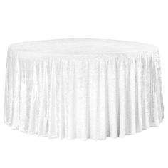 a white table cloth on top of a round table with a circular skirt around it