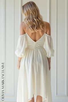 Olivia Mark - Elegant Cold-Shoulder Wrap Midi Dress with High-Low Hemline Elegant Off-shoulder Flowy Midi Dress, Spring Off-shoulder Bridesmaid Midi Dress, Spring Bridesmaid Off-shoulder Midi Dress, Cream Off-shoulder Dress For Brunch, Off-shoulder Bridesmaid Maxi Dress, White Flowy Off-shoulder Midi Dress, Elegant White High-low Hem Maxi Dress, Flowy High-low Hem Beach Dress, White Off-shoulder Asymmetrical Summer Dress