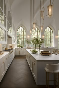 a large kitchen with lots of windows and white cabinets