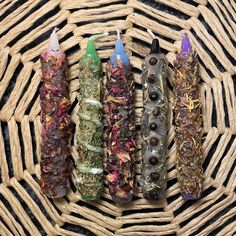 four different types of incenses on a wicker basket with some candles in the middle