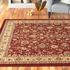 a living room area with a red rug on the floor