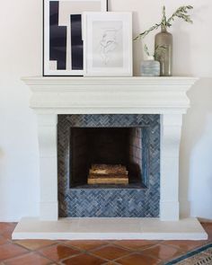 a fireplace with some pictures on top of it