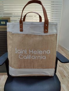 a brown and white bag sitting on top of a chair