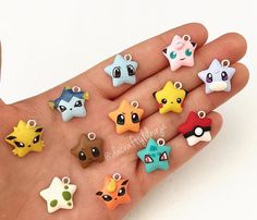 a hand holding a small assortment of pokemon charms