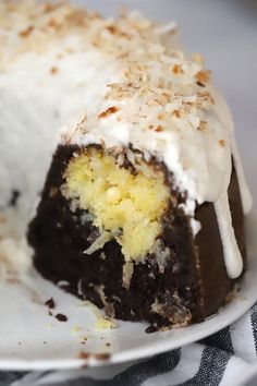 a close up of a cake on a plate with the words coconut filled chocolate bundt