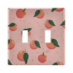 an orange pattern is on the pink light switchplates, which have leaves and peaches painted on them