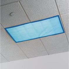 a blue rectangular object is suspended from the ceiling in an office building or conference room