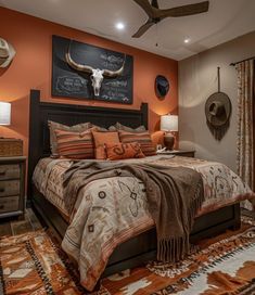 a bed room with a neatly made bed and a cow skull mounted to the wall