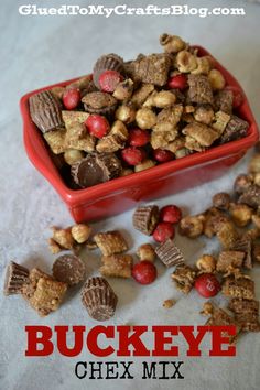 buckeye chex mix is in a red bowl and next to it is some candy