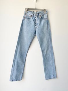 "Vintage Levi's 501  w25\" L31\" 1999 Spain   Light blue stone wash denim  Follow me on Instagram for new listing  Deuxieme loved Denim  100% Cotton no stretch. Please make sure size is good for you as no returns.  please read measurements before buying and ask any questions no returns Measurements taken laying flat.  Some stitch near buttons but doesn't affect the jeans just visible and noted.  Waist 32cm/12.5\" across flat (25\"total)  Crotch to waist 26cm 10.2\" Hips 49.5cm\" across flat 19.4\" total 38.9\"  Thigh across flat 26.5cm/10.4\" across  inside leg from crotch 79cm 31.1\" Ankle 18cm/6.6\" across flat  The tag is w25 L30 but please use measurements below not the tag.  If you have a pair of vintage levis compare measurements to get the best fit. Also always happy to help if you Classic Fitted Washed Blue Jeans, Classic Light Wash Jeans For Streetwear, Classic Fitted Jeans For Streetwear, Classic Fitted Light Wash Jeans, Classic Light Wash Jeans With Button Closure, Classic Fitted Washed Jeans, Levis Vintage, Jean Vintage, Vintage Levis 501