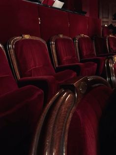 rows of red velvet seats in an auditorium