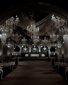 an elaborately decorated hall with chandeliers and tables