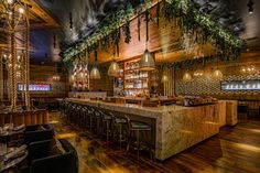 the bar is decorated with greenery and hanging lights