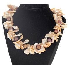 These magnificent Pearl shells surround the glowing bright real cultured round different colored Pearls. The largest of the shells are approximately 30mm long. The Pearls are approximately 12mm round. This 19 inch long necklace has a beautiful easy to use gold plated slide-in clasp. This is absolutely magnificent on a brown or black blouse or sweater where the Pearls glitter goldy. Handmade Pearl Necklace With Shell Shape, Luxury Unique Mother Of Pearl Shell Necklace, Handmade Shell-shaped Pearl Necklace, Real Pearl Jewelry, Gold Shell-shaped Pearl Necklace, Unique Beaded Shell-shaped Necklace, Luxury Multi-strand Pearl Necklace, Colored Pearls, Diy Jewelry Display