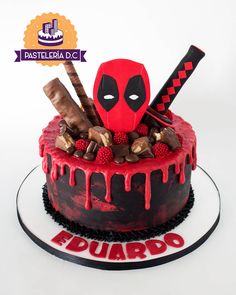 a deadpool themed cake with chocolate and raspberries