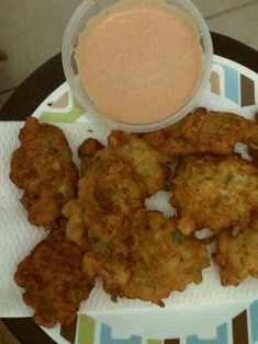 fried food on a plate with dipping sauce