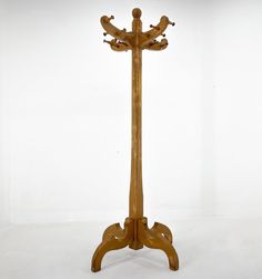 a wooden coat stand with birds on it