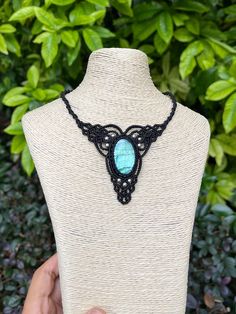 Embrace nature's beauty with this stunning handcrafted macrame necklace. At its heart lies a mesmerizing blue-green labradorite stone, known for its ethereal play of colors that shimmer like the northern lights. Key features: * Centerpiece: Oval blue labradorite cabochon * Necklace style: Adjustable  * Material: Durable black wax cord * Technique: Intricate macrame knotwork * Style: Bohemian, earthy, organic This necklace beautifully marries skilled craftsmanship with raw natural elements. The l Handmade Artisan Necklaces With Waxed Cord, Spiritual Macrame Jewelry With Waxed Cord, Handmade Artisan Necklace With Waxed Cord, Handmade Cord Spiritual Jewelry, Nature-inspired Macrame Necklaces For Festivals, Handmade Bohemian Cord Jewelry, Nature-inspired Macrame Necklace For Festivals, Handmade Turquoise Crystal Necklace, Handmade Turquoise Jewelry With Waxed Cord