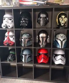 star wars helmets are lined up in a bookcase