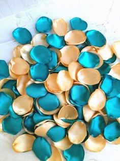 a pile of blue and gold hearts sitting on top of a table