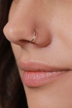 a woman with a nose piercing on her nose