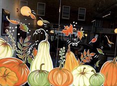 an image of pumpkins and gourds in the window