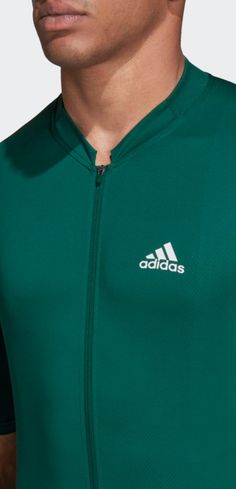 a man wearing a green adidas jersey