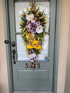 the front door is decorated with flowers and ribbons