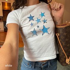 Dive into the nostalgia of the Y2K era with this coquette style vintage blue star print T-shirt. Perfect for those who adore the adult baby tee look, this top features a collection of distressed stars that add a pop of color and personality to any outfit. Whether you're layering up or wearing it on its own, this tee is a versatile addition to your wardrobe. Pair it with your favorite jeans or a cute skirt for an effortlessly chic look.   Looking for a graphic baby tee nostalgic of the 90s? Bring Bebe T Shirt, Graphic Baby Tee, Fits Aesthetic, Star T Shirt, Baby Graphic Tees, Y2k Baby Tee, Blue Stars, Baby T Shirts, Girls Denim