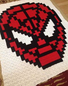 a close up of a knitted deadpool blanket