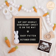 a sign that says hip hop hooray baby 3 is on the way next to some carrots