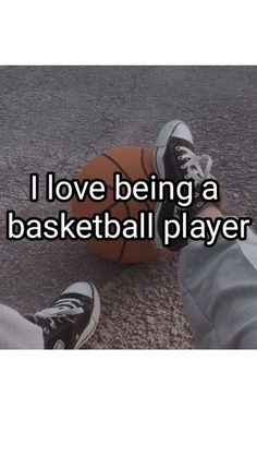 someone is sitting on the ground with their feet up next to a basketball that says i love being a basketball player