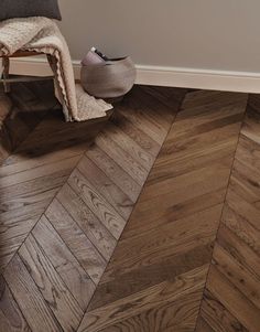 a wooden floor with a chair next to it