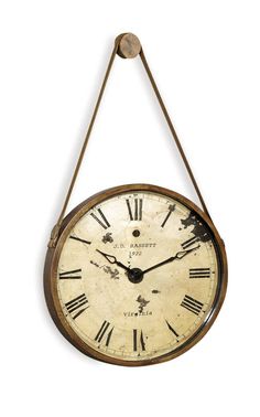 an old clock hanging from a rope with roman numerals on the face and hands