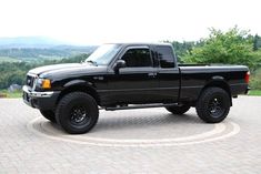 a black pickup truck parked in a parking lot