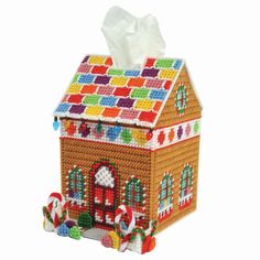 a gingerbread house tissue box is decorated with candy