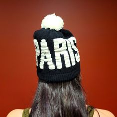 Black Knit Had With White Paris Lettering And White Pom Pom. No Tags But New And Never Worn. Black Beanie Hat With Letter Print, White Letter Print Hats For Winter, White Letter Print Winter Hats, White Winter Hats With Letter Print, Trendy Black Winter Hat, Black Winter Hat With Letter Print, Trendy Black Knitted Hats, Cossack Hat, Fedora Women