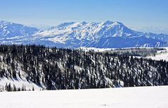 a person standing on top of a snow covered slope