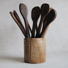 wooden spoons and spatulas in a ceramic cup