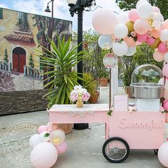 an ice cream cart decorated with balloons and flowers for a baby shower or birthday party